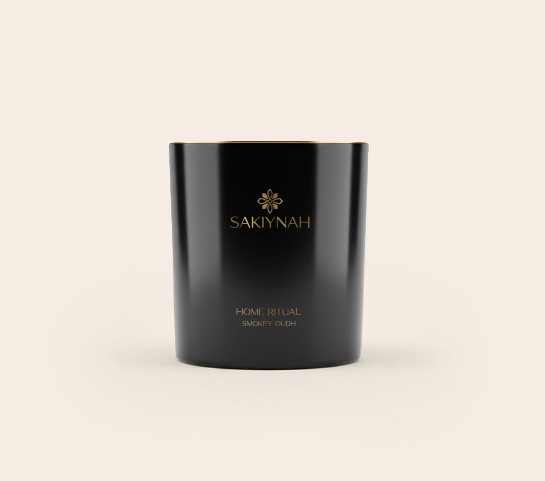 Black candle Oudh scent with 'Sakiyah' branding on a light beige background