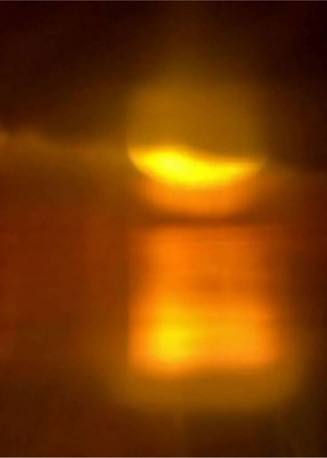 Orange and yellow blurred abstract light reflection creating a warm glowing effect