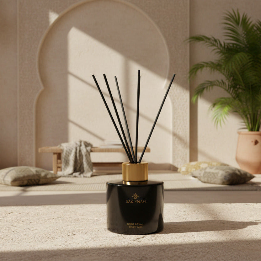 Black diffuser bottle with gold cap and black sticks in a Arabic styled living room