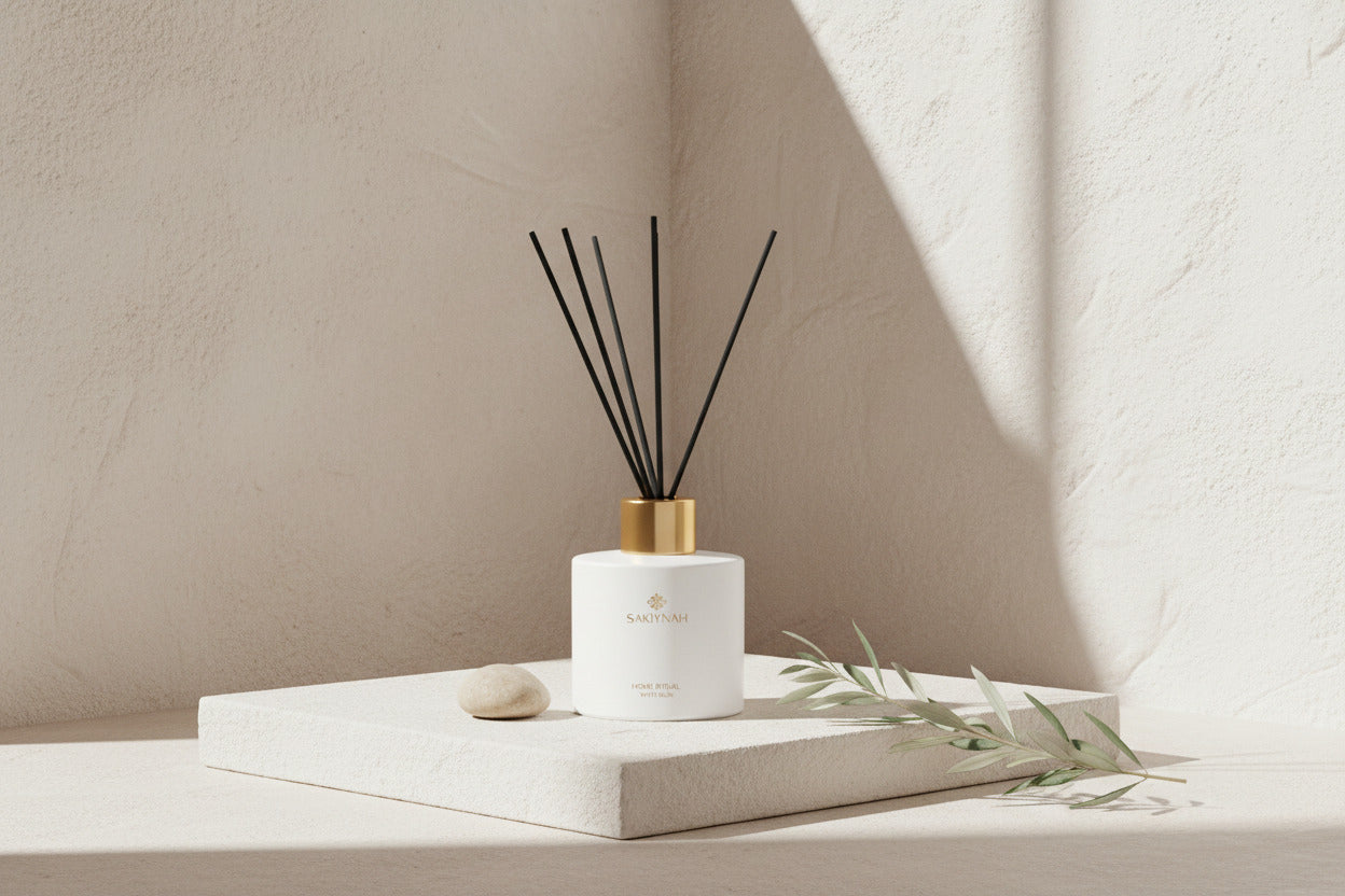 White diffuser bottle with black sticks on a beige background