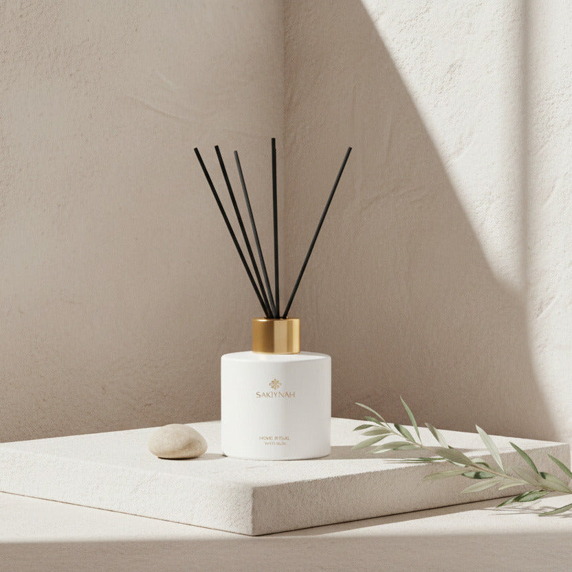 White diffuser bottle with black sticks on a beige background